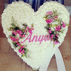   Szívkoszorú fehér szegfűvel felirattal és rózsaszín virágdíszítéssel